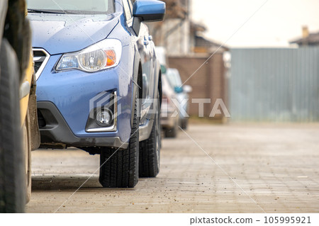 Cars parked in a row on a city street side. Cars parked in a row on a city street side. 105995921