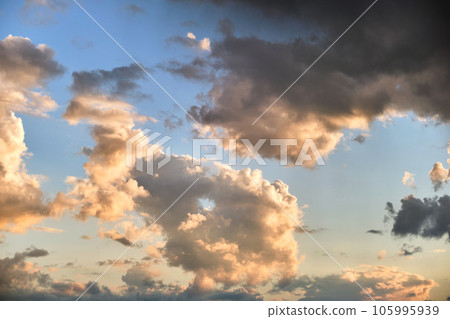 Bright landscape of dark clouds on yellow sunset sky in evening. Bright landscape of dark clouds on yellow sunset sky in evening. 105995939