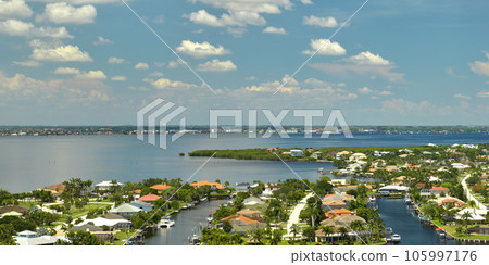 Aerial view of residential suburbs with private homes located on gulf coast near wildlife wetlands with green vegetation on sea shore. Living close to nature concept Aerial view of residential suburbs with private homes located on gulf coast near wildlife wetlands with green vegetation on sea shore. Living close to nature concept 105997176