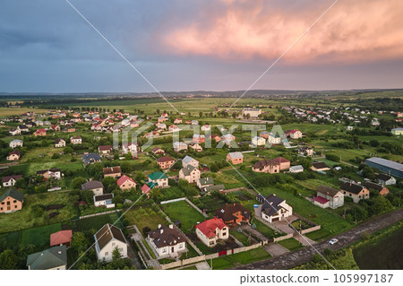 Aerial view of residential houses in suburban rural area at sunset 105997187