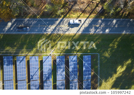 Aerial view of large sustainable electrical power plant with rows of solar photovoltaic panels for producing clean electric energy. Concept of renewable electricity with zero emission 105997242