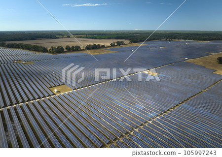 Aerial view of large sustainable electrical power plant with rows of solar photovoltaic panels for producing clean electric energy. Concept of renewable electricity with zero emission 105997243