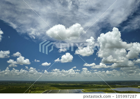 Aerial view of large sustainable electrical power plant with rows of solar photovoltaic panels for producing clean electric energy. Concept of renewable electricity with zero emission Aerial view of large sustainable electrical power plant with rows of solar photovoltaic panels for producing clean electric energy. Concept of renewable electricity with zero emission 105997287