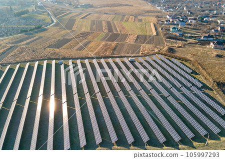 Aerial view of large sustainable electrical power plant with rows of solar photovoltaic panels for producing clean ecological electric energy. Renewable electricity with zero emission concept 105997293
