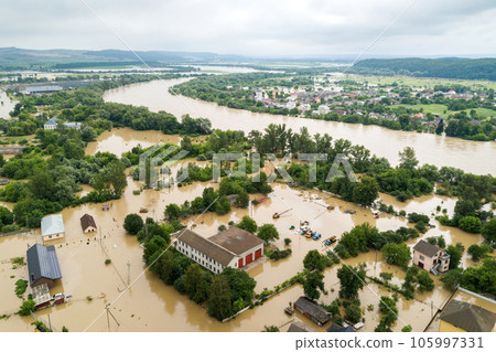 Aerial view of flooded houses with dirty water of Dnister river in Halych town, western Ukraine. 105997331