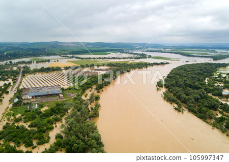 Aerial view of Dnister river with dirty water and flooded houses in Halych town, western Ukraine. 105997347