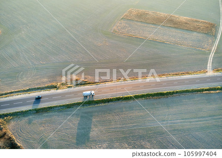Aerial view of cargo truck driving on highway hauling goods. Delivery transportation and logistics concept 105997404