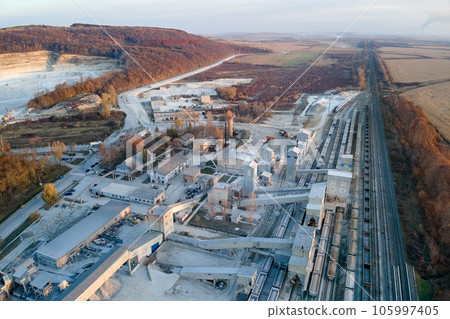 Aerial view of cargo train loaded with crushed stone materials at mining factory. Railway transportation of grinded limestone ore 105997405