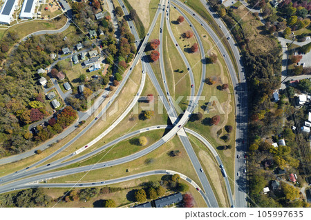 Aerial view of american freeway intersection with fast moving cars and trucks. USA transportation infrastructure concept 105997635