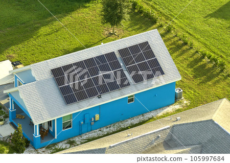 Aerial view building roof with rows of blue solar photovoltaic panels for producing clean ecological electric energy. Renewable electricity with zero emission concept Aerial view building roof with rows of blue solar photovoltaic panels for producing clean ecological electric energy. Renewable electricity with zero emission concept 105997684