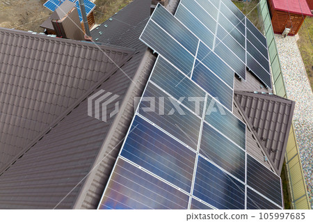 Aerial view building roof with rows of blue solar photovoltaic panels for producing clean ecological electric energy. Renewable electricity with zero emission concept Aerial view building roof with rows of blue solar photovoltaic panels for producing clean ecological electric energy. Renewable electricity with zero emission concept 105997685