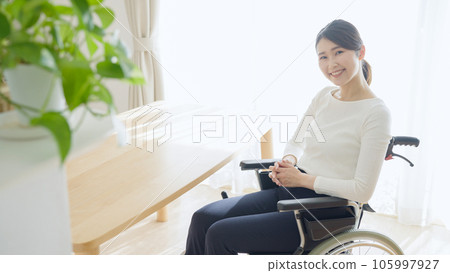 A woman riding a wheelchair A woman riding a wheelchair 105997927