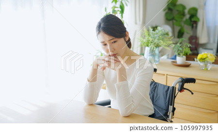 Depressed woman in a wheelchair 105997935