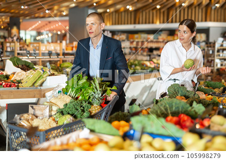 Portrait of a confident young couple in the supermarket Portrait of a confident young couple in the supermarket 105998279