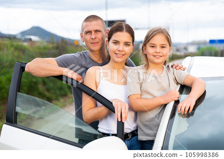 Happy family posing near new car 105998386