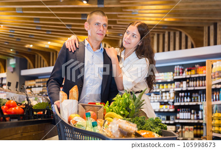 Couple shopping at vegetables department at supermarket Couple shopping at vegetables department at supermarket 105998673