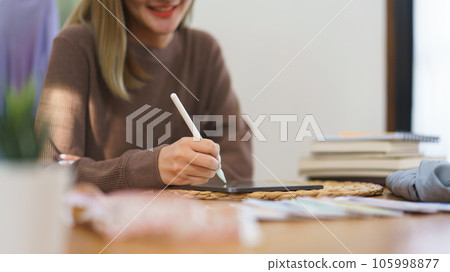 Fashion design concept, Fashion designer drawing new collection clothes on tablet in home office 105998877