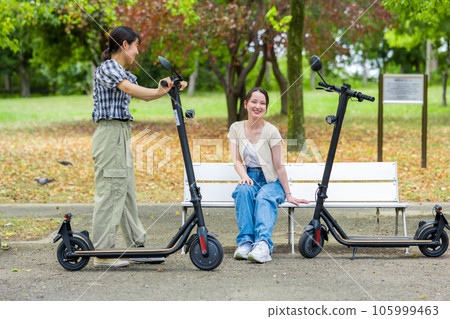 A young woman who meets on an electric kickboard and has a fun conversation | Electric kickboard image 105999463
