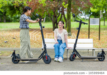 A young woman who meets on an electric kickboard and has a fun conversation | Electric kickboard image 105999464