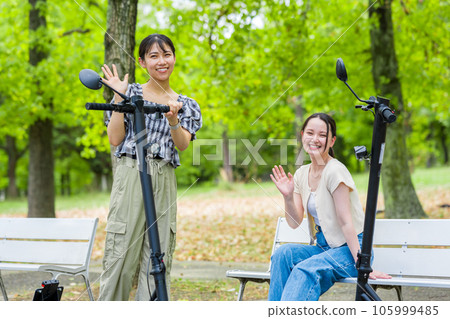 A young woman who meets on an electric kickboard and has a fun conversation | Electric kickboard image 105999485