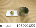 Matcha tea bowl with matcha and Japanese sweets on paper 106001855