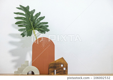 Satai Modern pottery with monstera leaves on a wooden shelf against a white wall background. Handmade pottery. Thailand's native handicrafts. 106002532