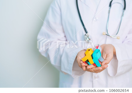 World cancer day, February 4. Doctor hold colorful ribbons, blue, yellow, red, green, white, pink and grey for supporting people living and illness. Health, Medical, awareness and Insurance concept World cancer day, February 4. Doctor hold colorful ribbons, blue, yellow, red, green, white, pink and grey for supporting people living and illness. Health, Medical, awareness and Insurance concept 106002654