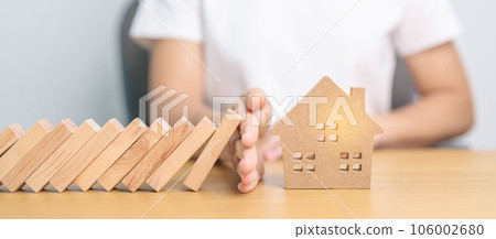 hand stop falling wood blocks and protect house model. Crisis, fall Business, Risk, Economic recession, Developer, Real Estate and Property concept hand stop falling wood blocks and protect house model. Crisis, fall Business, Risk, Economic recession, Developer, Real Estate and Property concept 106002680