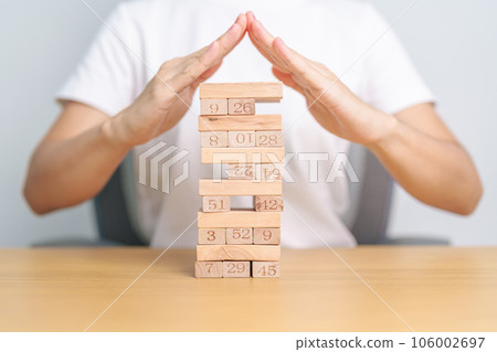 hand cover wooden block on the tower. Business planning, Risk Management, Solution, insurance and strategy Concepts hand cover wooden block on the tower. Business planning, Risk Management, Solution, insurance and strategy Concepts 106002697