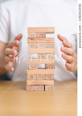 hand cover wooden block on the tower. Business planning, Risk Management, Solution, insurance and strategy Concepts hand cover wooden block on the tower. Business planning, Risk Management, Solution, insurance and strategy Concepts 106002698