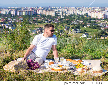 Young man has a picnic by the cityview Young man has a picnic by the cityview 106004366
