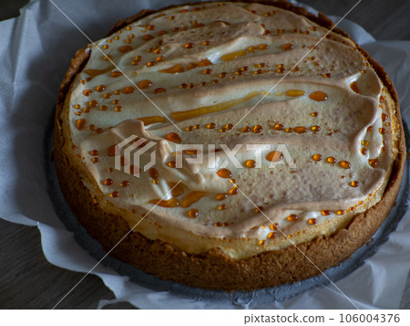 Classical cheesecake with meringue on white paper background Classical cheesecake with meringue on white paper background 106004376