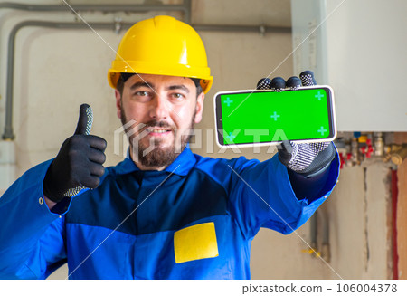 Portrait of worker or engineer in blue work clothes and yellow safety helmet Portrait of worker or engineer in blue work clothes and yellow safety helmet 106004378