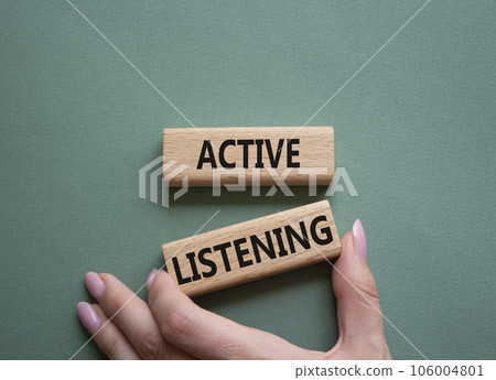 Active listening symbol. Wooden blocks with words Active listening. Businessman hand. Beautiful grey green background. Business and Active listening concept. Copy space. Active listening symbol. Wooden blocks with words Active listening. Businessman hand. Beautiful grey green background. Business and Active listening concept. Copy space. 106004801
