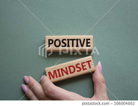 Positive Mindset symbol. Concept words Positive Mindset on wooden blocks. Businessman hand. Beautiful grey green background. Business and Positive Mindset concept. Copy space. Positive Mindset symbol. Concept words Positive Mindset on wooden blocks. Businessman hand. Beautiful grey green background. Business and Positive Mindset concept. Copy space. 106004802