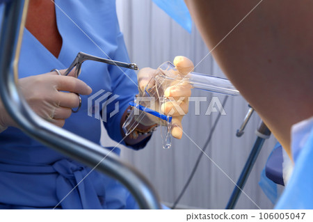 A gynecologist performs a cervical biopsy. Gynecological chair. A woman at the gynecologist for a check-up. 106005047