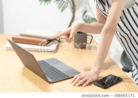 Woman pointing at laptop screen Woman pointing at laptop screen 106005171