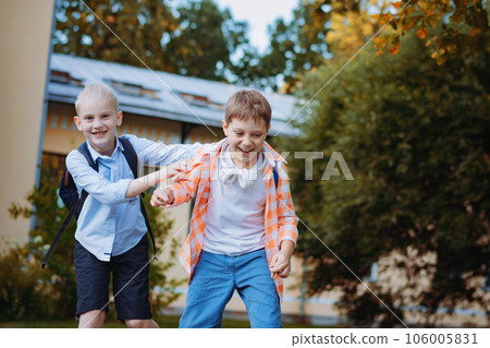 cheerful excited boys running home from school 106005831
