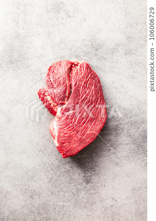 Raw fillet steak beef meat on kitchen table. Top view. Raw fillet steak beef meat on kitchen table. Top view. 106006729