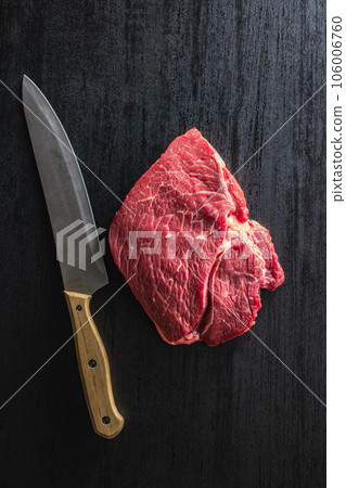 Raw fillet steak beef meat on black table. Top view. 106006760