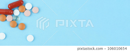 Assorted pharmaceutical medicine pills, tablets and capsules over blue background Assorted pharmaceutical medicine pills, tablets and capsules over blue background 106010654