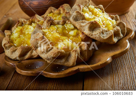 Karelian pasty with apples and apricot Karelian pasty with apples and apricot 106010683
