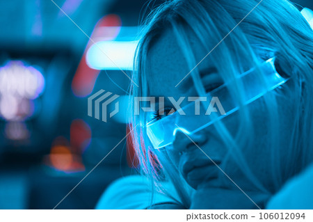 Portrait of a blonde in neon glasses. 106012094