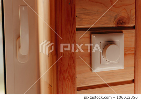 Close up electrical dimmer switch light for adjustable brightness control in wooden house 106012356