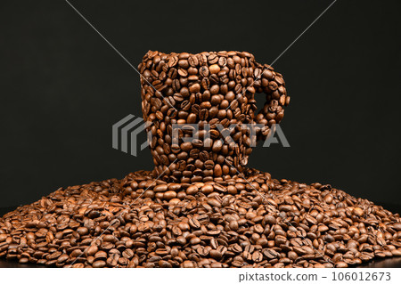 Cup of coffee made from roasted coffee beans isolated on black background 106012673