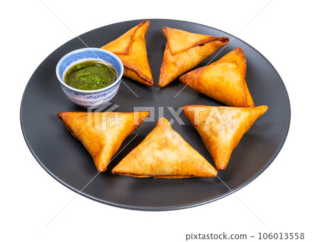 several triangular fried empanadas on black plate several triangular fried empanadas on black plate 106013558