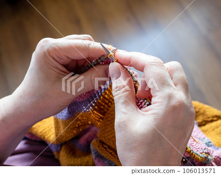 first-person view of hand knitting sweater closeup first-person view of hand knitting sweater closeup 106013571