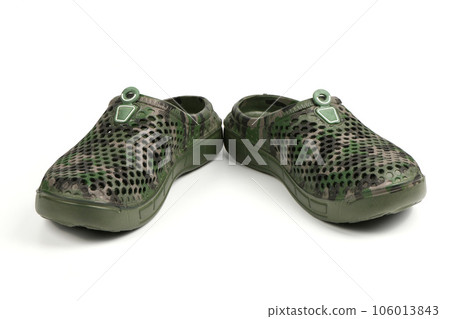 Pair dark green galoshes isolated on a white background. Shoes for rainy weather. Pair dark green galoshes isolated on a white background. Shoes for rainy weather. 106013843