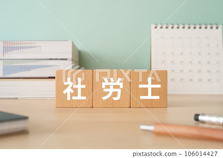 A desk with a block written as a social worker 106014427