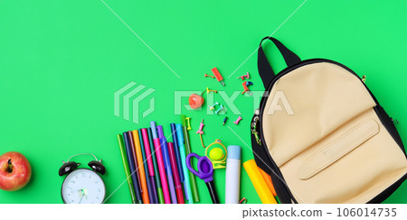 School accessories with school bag on green background with copy space School accessories with school bag on green background with copy space 106014735